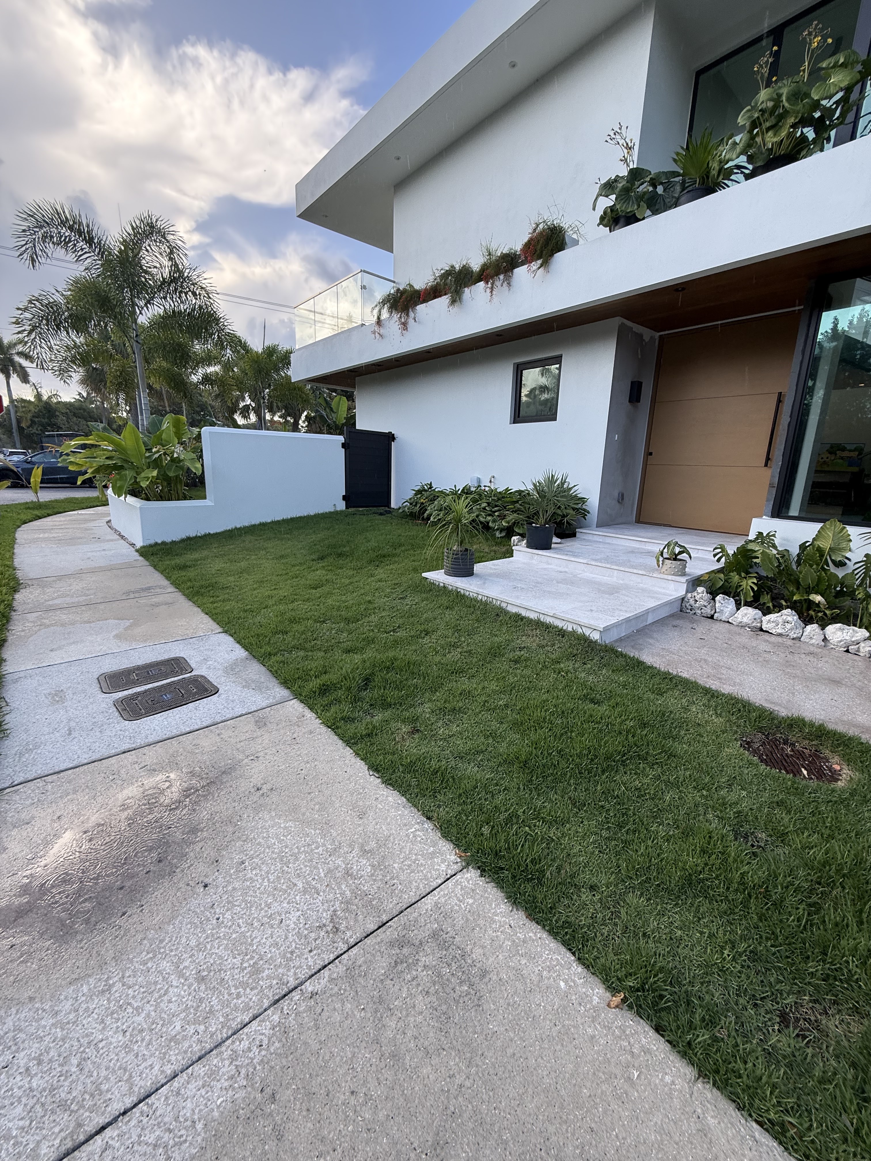 Manicured front lawn and landscaping at a modern South Florida home